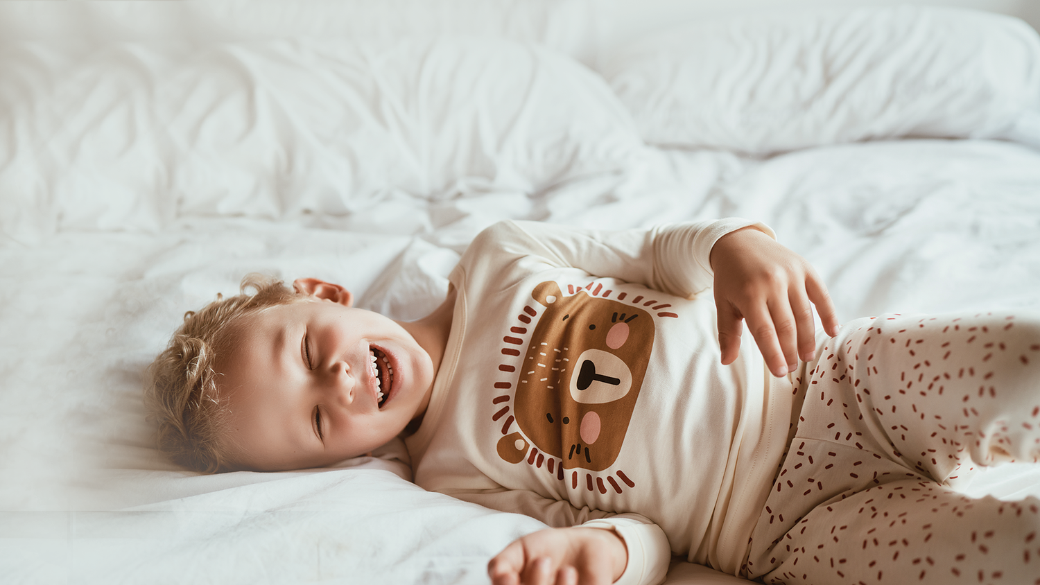 Happy Child in Comfortable Dreamy Lion Children's Pajamas Smiling while playing